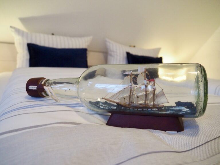 Modellschiff in einer Flasche auf einem Doppelbett im Hotel Friesenhuus